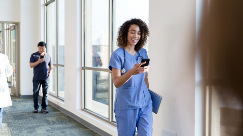 Happy nurse texting