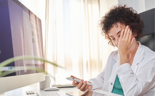 Exhausted woman holding phone