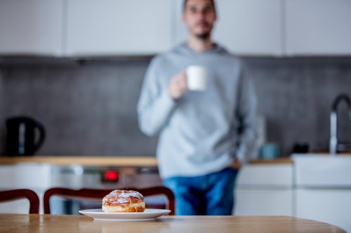 Man looks skeptically at donut