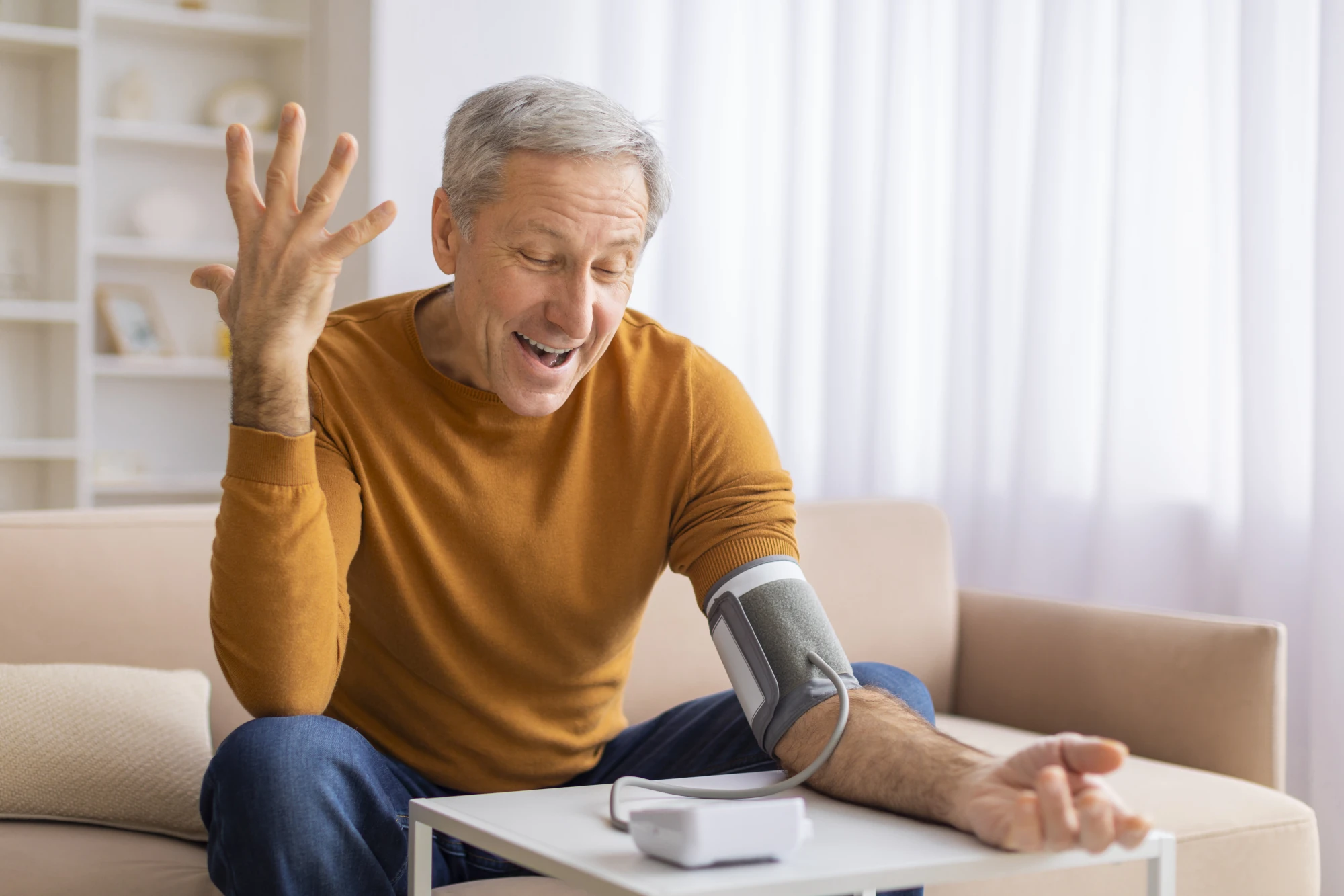 Man taking blood pressure at home