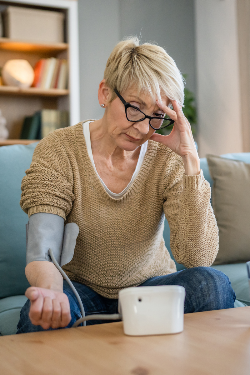 Woman taking blood pressure at home